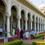 Group of visitors strolling outside the historic Aga Khan Palace in Pune, India