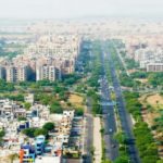 Aerial view of Kiwale Pune with Mumbai Pune Expressway, green landscape, and new residential projects.