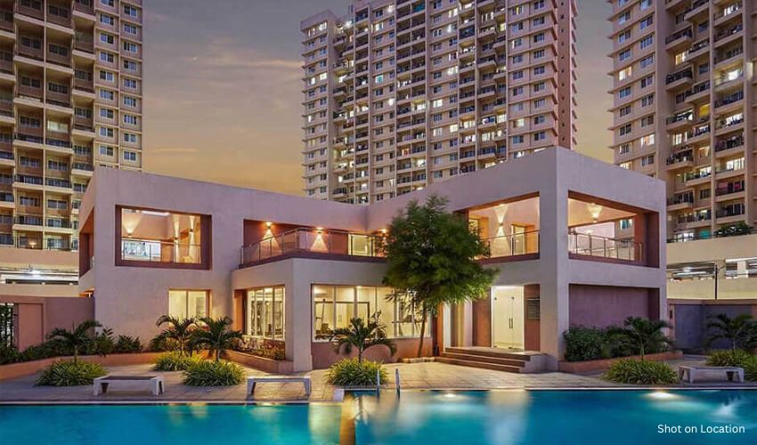 Premium gated community in Pune with clubhouse and landscaped walkways.