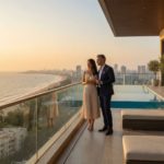 Couple enjoying sea view from Serenova Mumbai luxury apartments near Versova Beach.