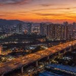 Aerial view of Mumbai flyover highway connecting western and eastern suburbs at twilight with city skyline