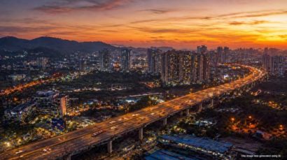 Aerial view of Mumbai flyover highway connecting western and eastern suburbs at twilight with city skyline